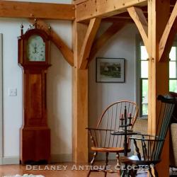 A New England tall clock in a post and beam room.
