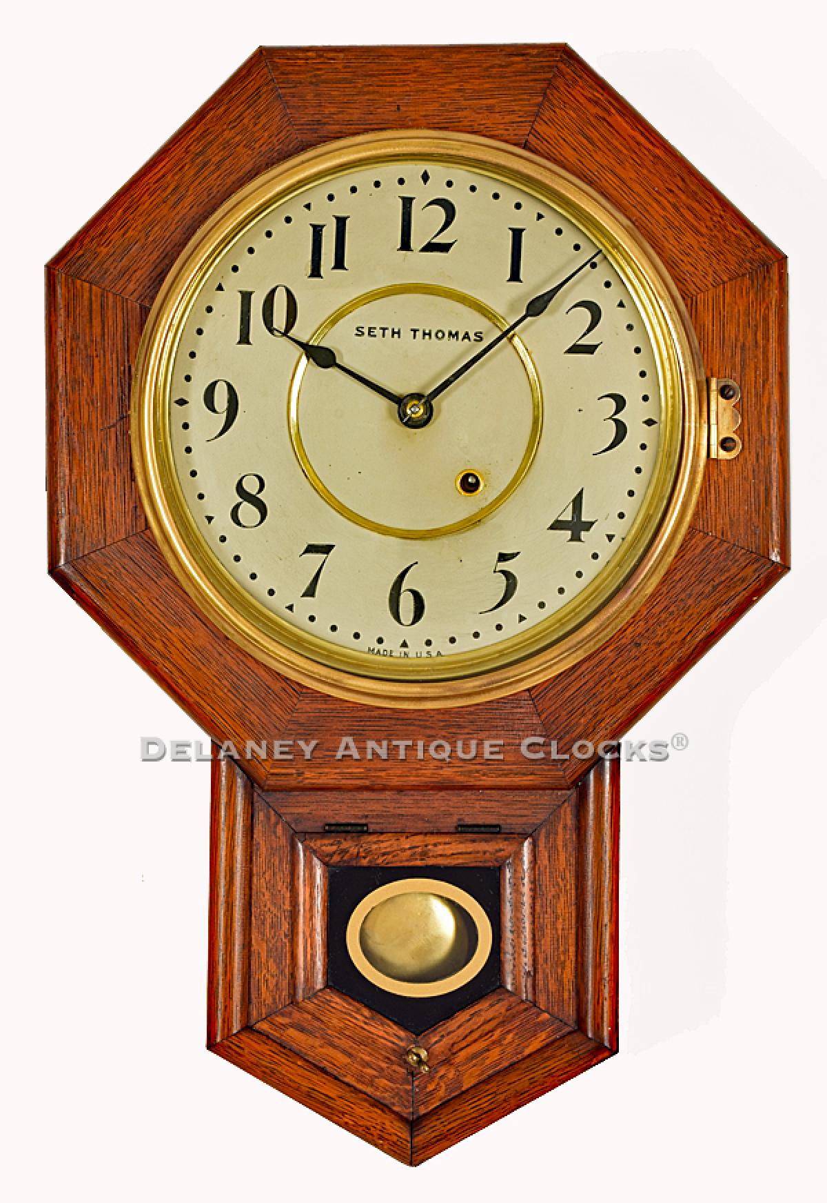 Seth Thomas 10 Inch Drop Octagon wall clock. A school house clock in an oak case. 219024.