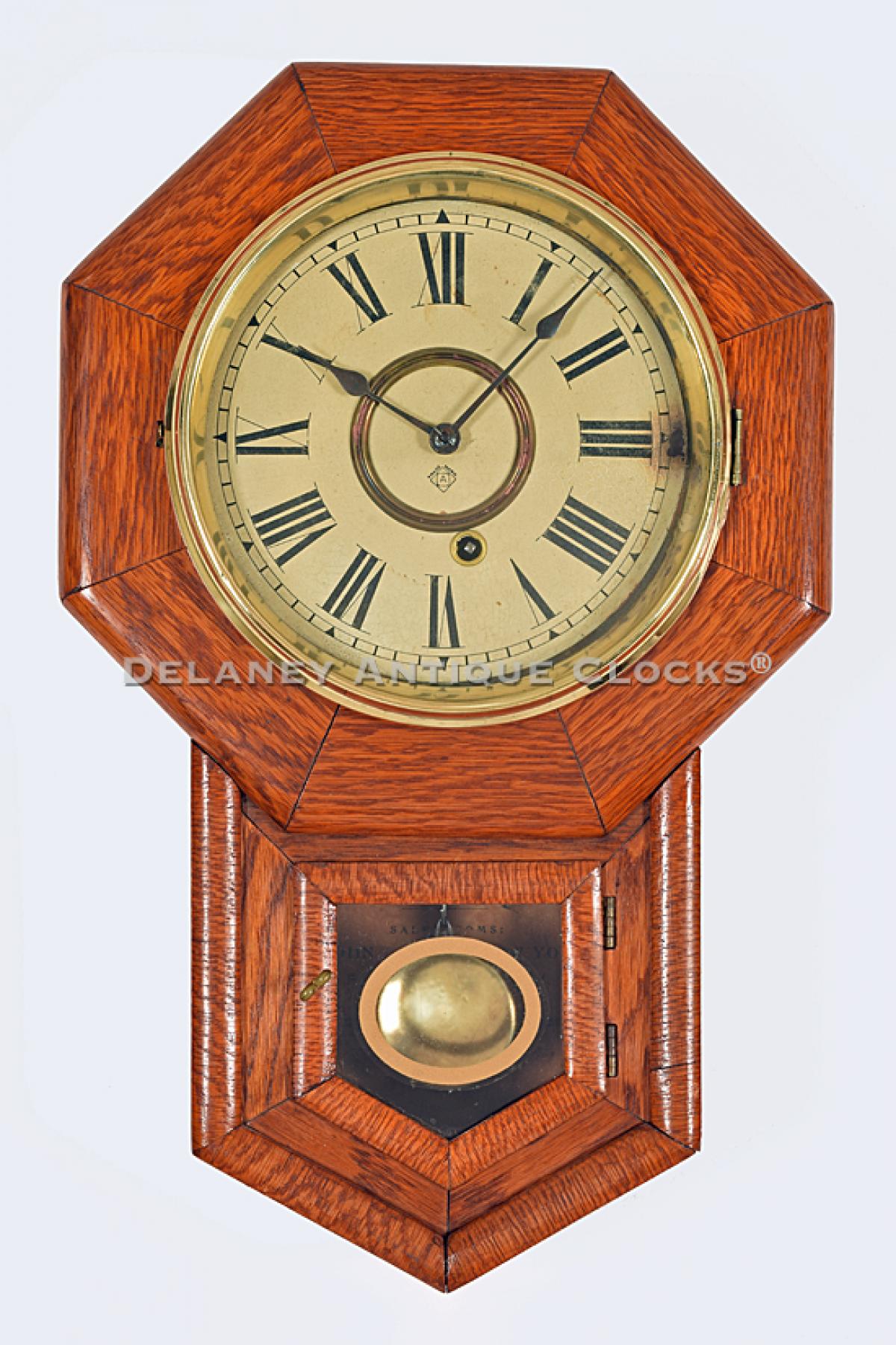 Ansonia Clock Co. 8-Inch Drop Octagon in oak. School clock. 219139. Delaney Antique Clocks.