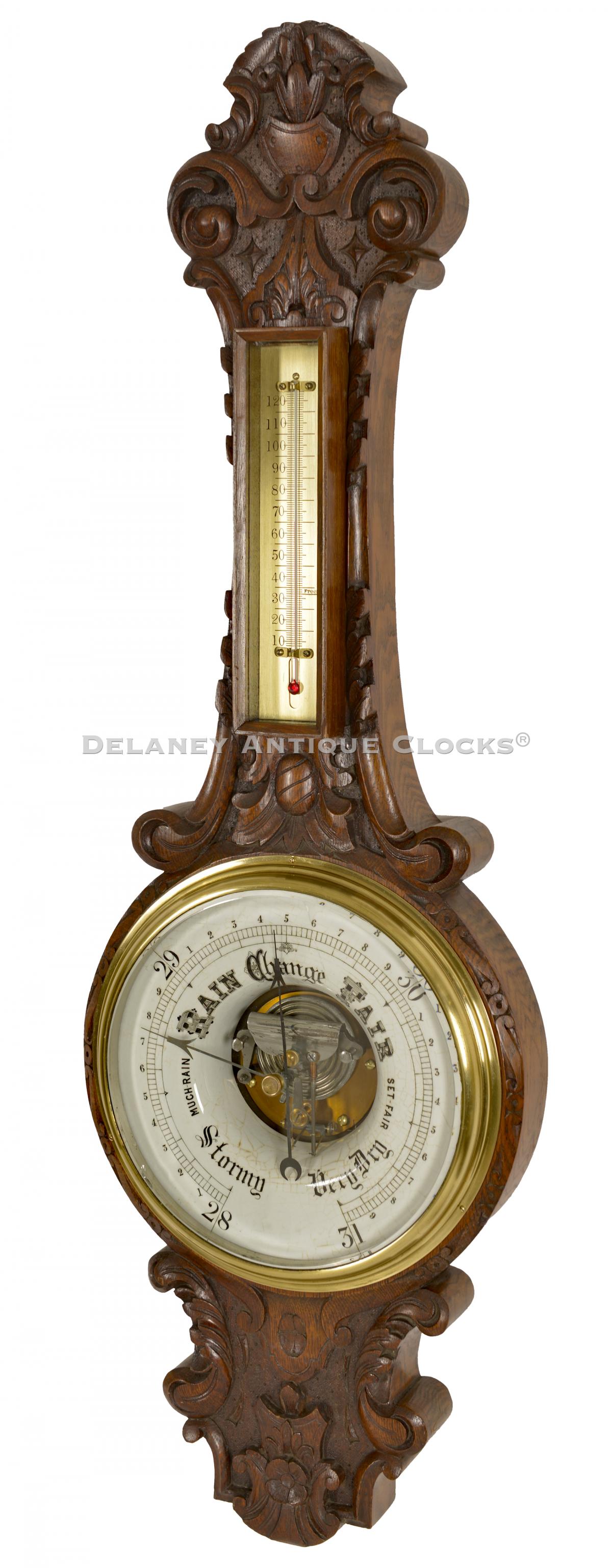 Carved walnut case aneroid barometer. 222101. Delaney Antique Clocks.