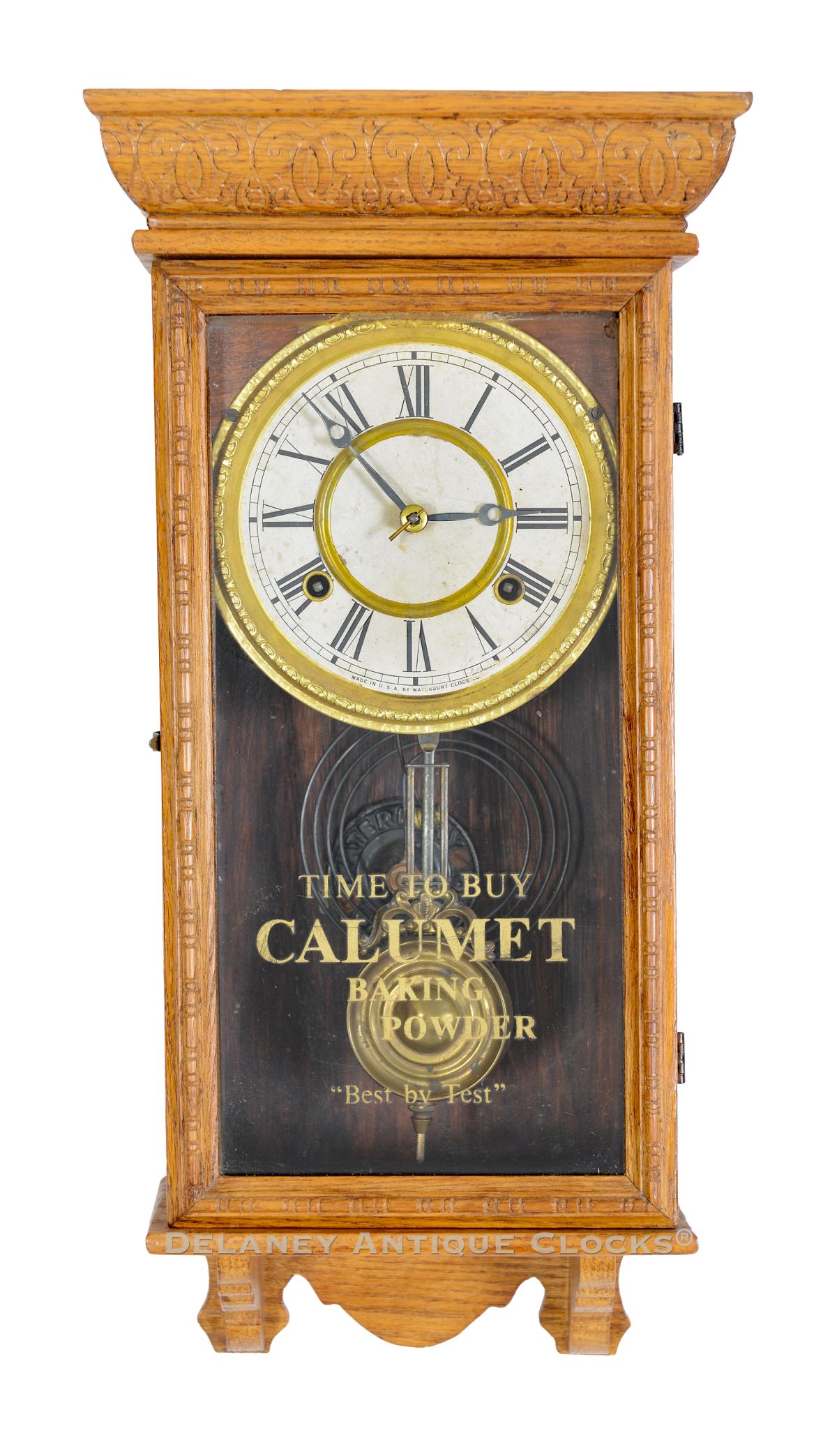 A Waterbury Minature Box Regulator with Calumet advertising on the door glass. 224056.