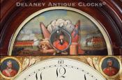 Automated tall clock dial with cannons. 222136. Delaney Antique Clocks. 