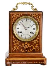 French-origin mantel clock. Marked "H. Marc Paris" on the dial and movement. A diminutive rosewood veneered case with decorative parquetry inlays. CCC-31.