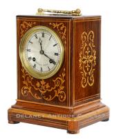 French-origin mantel clock. Marked "H. Marc Paris" on the dial and movement. A diminutive rosewood veneered case with decorative inlays. CCC-31.