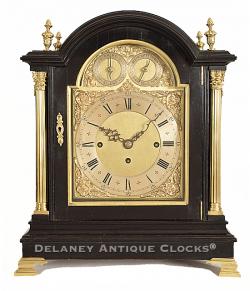 A fine English made quarter striking Bracket clock or Table Clock. The case is finished in black lacquer and decorated with applied brass castings. The brass composite dial and three train movement are excellent quality. 219046.