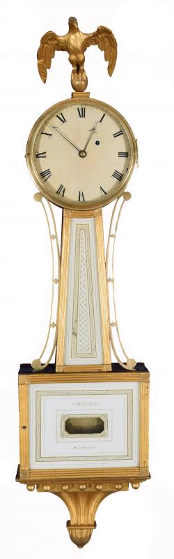 Simon Willard's Patent Timepiece. A wall clock commonly called a 'Banjo' clock. This fine example is gilded reeded frames and retains its original hand painted tablets. 2190011.