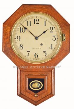 Seth Thomas 10 Inch Drop Octagon wall clock. A smaller schoolhouse clock in a red oak case. 222108.