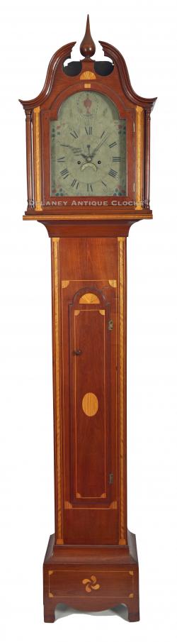  An elaborately inlaid cherry case tall clock of New England origin. This clock is unsigned. 23177.