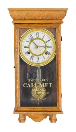 A Waterbury Minature Box Regulator with Calumet advertising on the door glass. 224056.