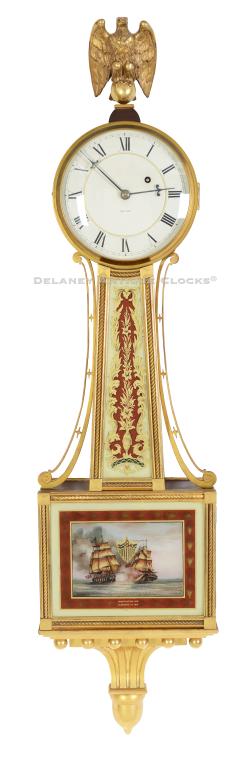 A suburb Waltham wall presentation timepiece or banjo clock featuring gilt rope frames and a painted scene of the Naval battle between the Constitution and the Guerriere. D. J. Steele Artist. 224097.