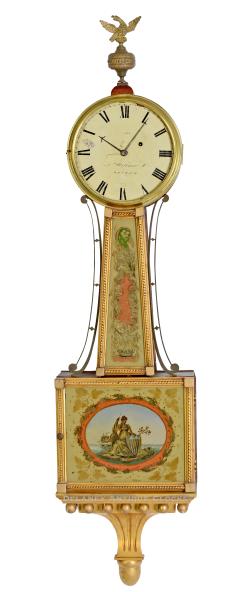 An Aaron Willard Jr. gilt frame wall timepiece or banjo clock made in Boston circa 1815. This exquisite piece of history, with the lower tablet depicting “Columbia,” offers a unique connection to the past for antique enthusiasts. EEE-15.