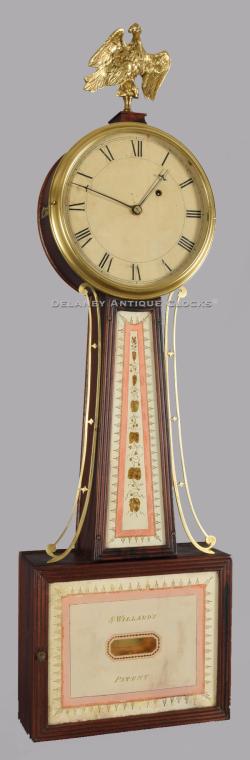 Simon Willard's Patent Timepiece. A wall clock commonly called a 'Banjo' clock. This fine example is fitted with reeded frames and retains its original tablets.