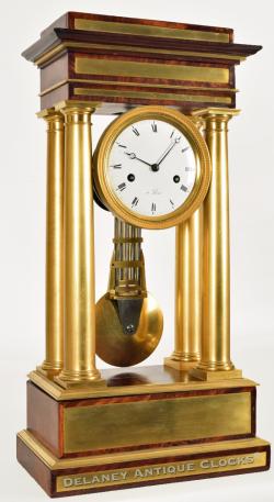 A large French portico clock featuring brass inlays and accents. 219088